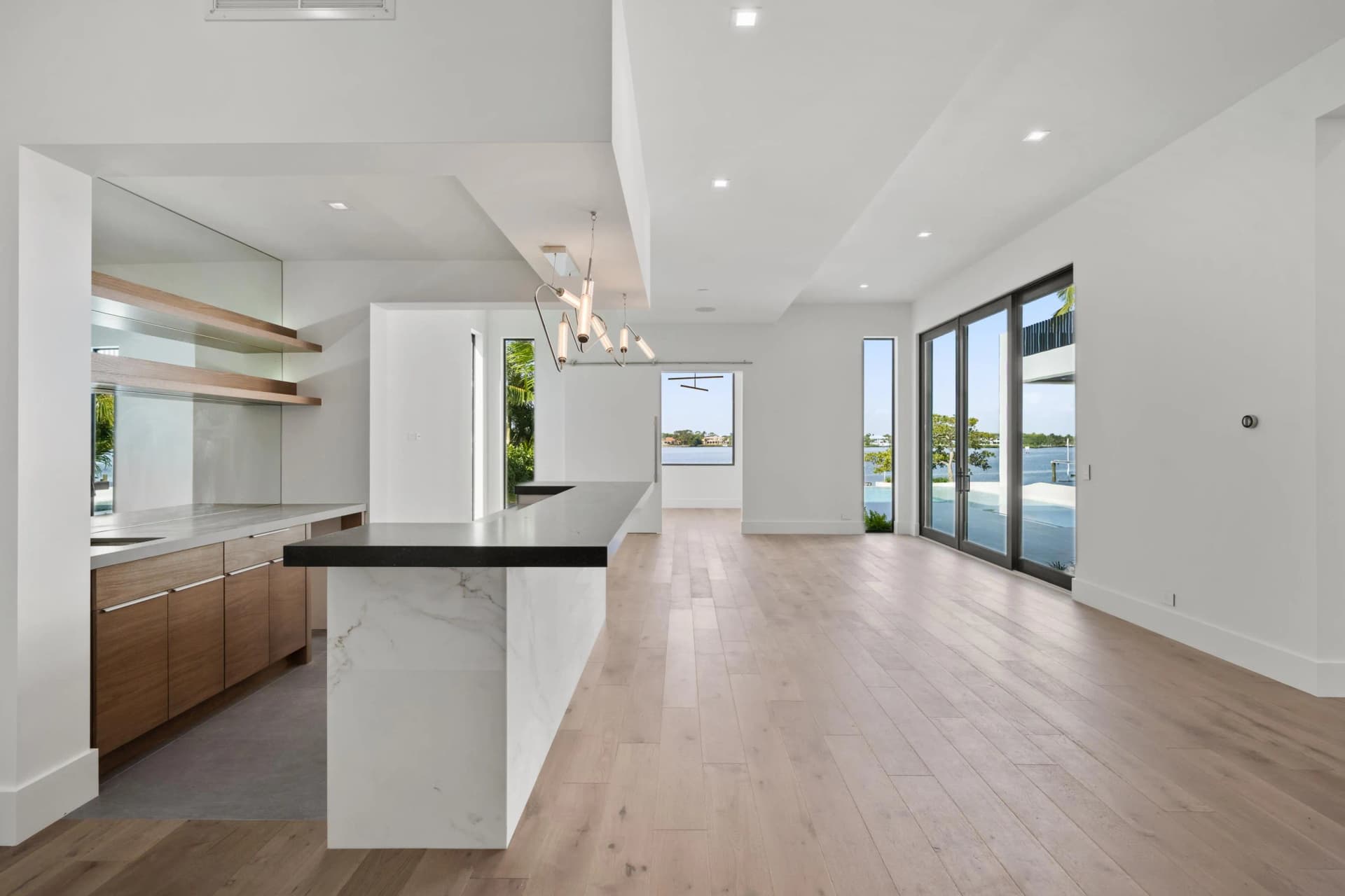 Kitchen with walnut island, marble counters, and waterfront views