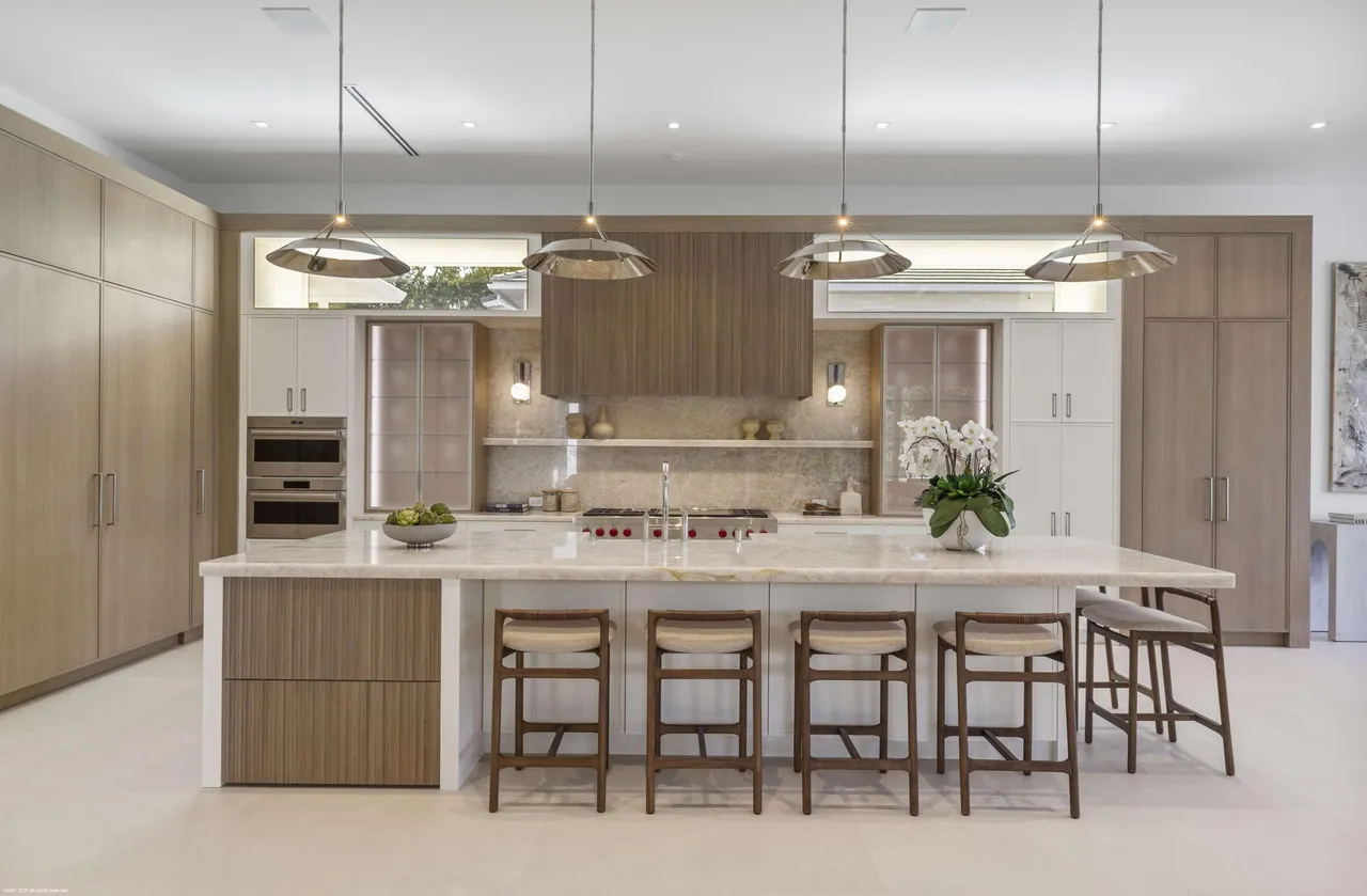 Chef's kitchen with marble island and oak cabinetry