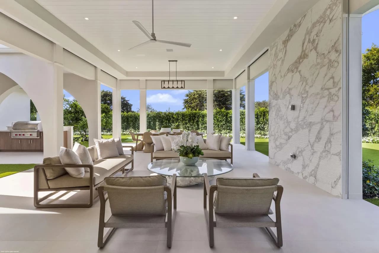 Covered outdoor dining with marble accent wall