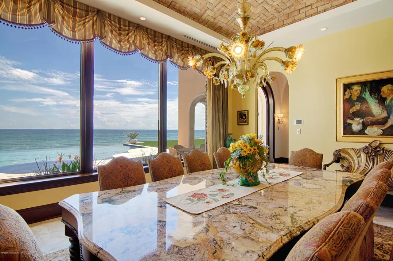 Formal dining with marble table and ocean views